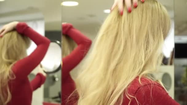 Young woman enjoying her new haircut in the mirror, closeup — Stock Video