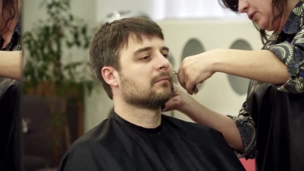 Friseur schneidet Mann im Salon den Bart — Stockvideo
