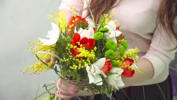 Florist is making a fresh bouquet with tulips