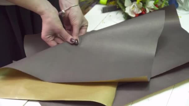 Флорист підготовці квітка обгорткового паперу — стокове відео