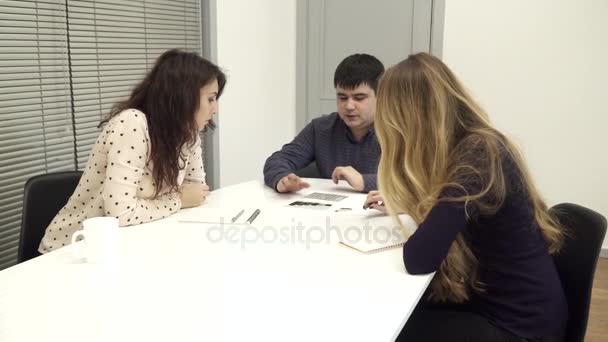 Jovens que têm uma reunião de negócios no escritório — Vídeo de Stock