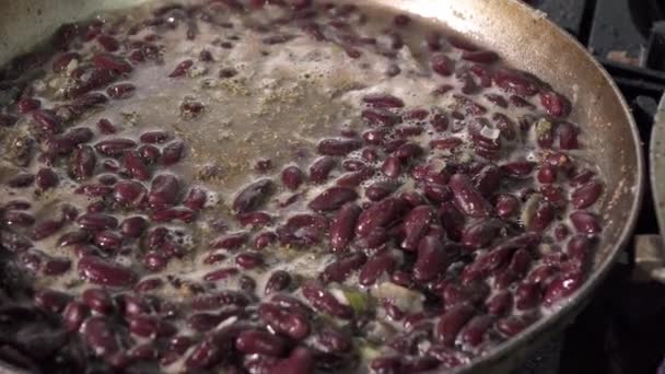 Red kidney beans frying in red sauce in pan, close-up. — Stock Video