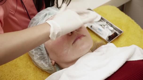 Schoonheidsspecialiste vrouw voorbereiden op de therapie in de beauty salon — Stockvideo