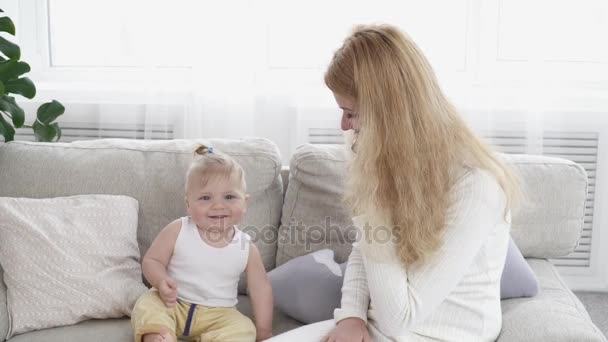 Baby boy wants to take the phone while his mother talking on it — Stock Video