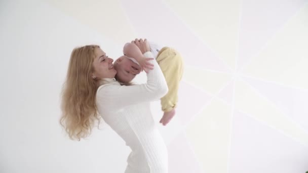 Young mother holding her baby boy on hands — Stock Video