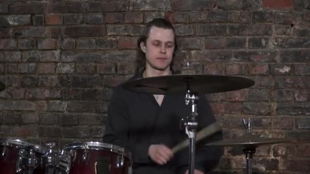 Молодой человек играет на барабанах на репетиции — стоковое видео