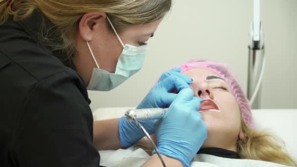 Beautician está haciendo el maquillaje permanente — Vídeo de stock