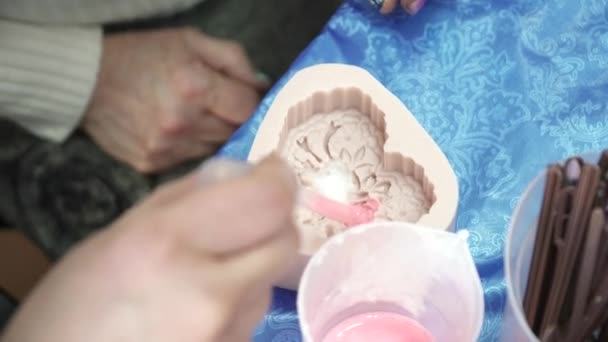 Femmes mains versant base de savon au modèle de coeur pour la création de savon à la main — Video