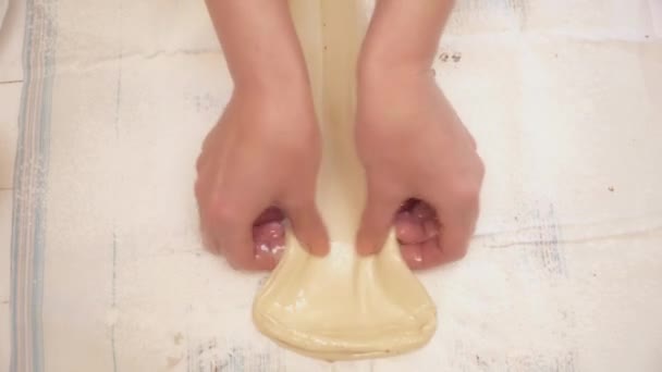 Womans hands spreading out the dough — Stock Video