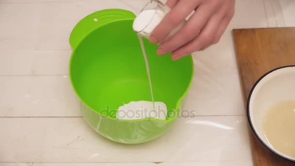 Womans hands adding milk to the bowl — Stock Video