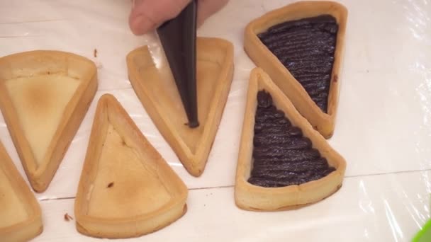 Adición de chokolate a las pequeñas tartas de primer plano — Vídeos de Stock