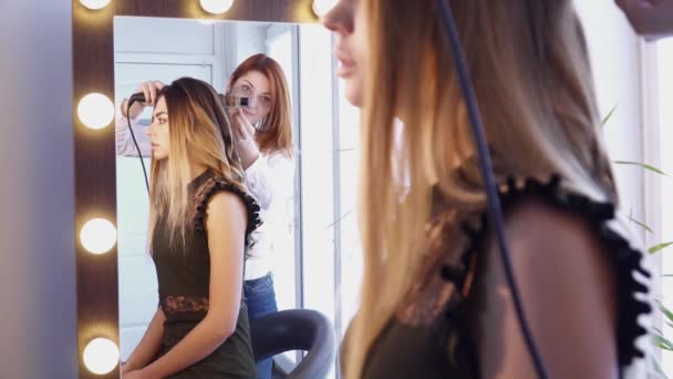 Peluquería femenina creando un peinado delante de la morror — Vídeo de stock