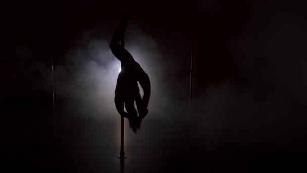 Young womans silhouette dancing near the pole — Stock Video