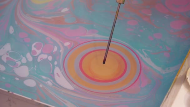 An artist making the paint drops on ebru technique picture slow motion — Stock Video
