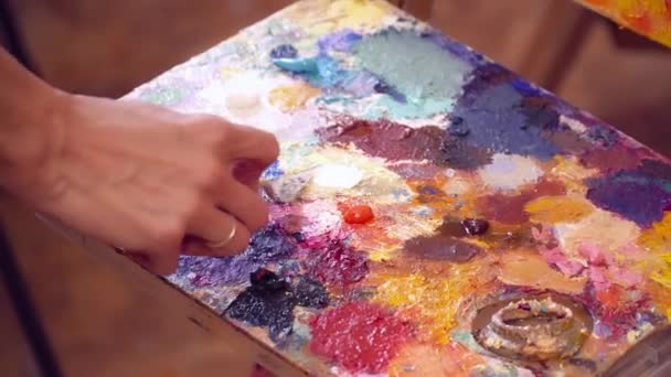 An artist taking the paint from the palette — Stock Video