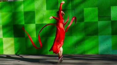 Genç kadın kırmızı kurdele yavaş hareket ile dans