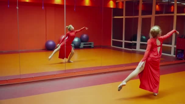 Jovem ginasta dançando na aula de dança em um vestido vermelho — Vídeo de Stock