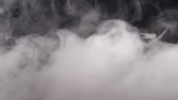 Strong white smoke filling in with wives the black background — Stock Video