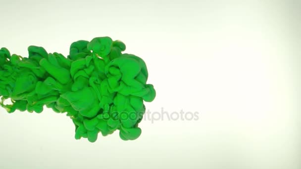 Ink of deep green color pouring into water on white background texture — Stock Video