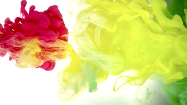 Tinta a sárga, a zöld és a piros szín ömlött a víz a fehér háttér textúra — Stock videók