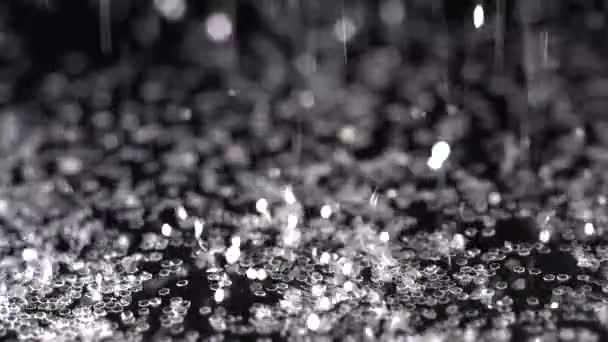 Siyah arka plan üzerine, soyut yavaş düşen beyaz köpüklü glitter — Stok video