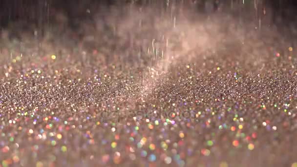 Golden glitter falling on the black background, abstract slow motion — Stock Video
