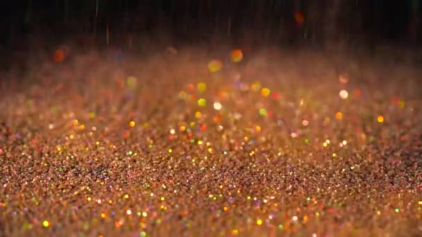 Orange glitter falling on the black background, abstract slow motion — Stock Video