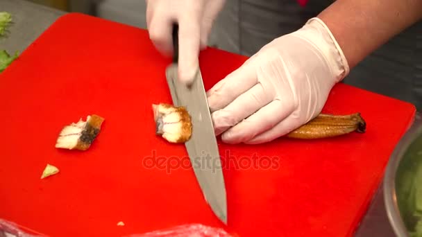 Closeup šéfkuchař řezání úhoře na tabuli v restauraci — Stock video