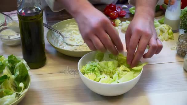 Chef préparant une salade fraîche avec des légumes sur la table en bois — Video