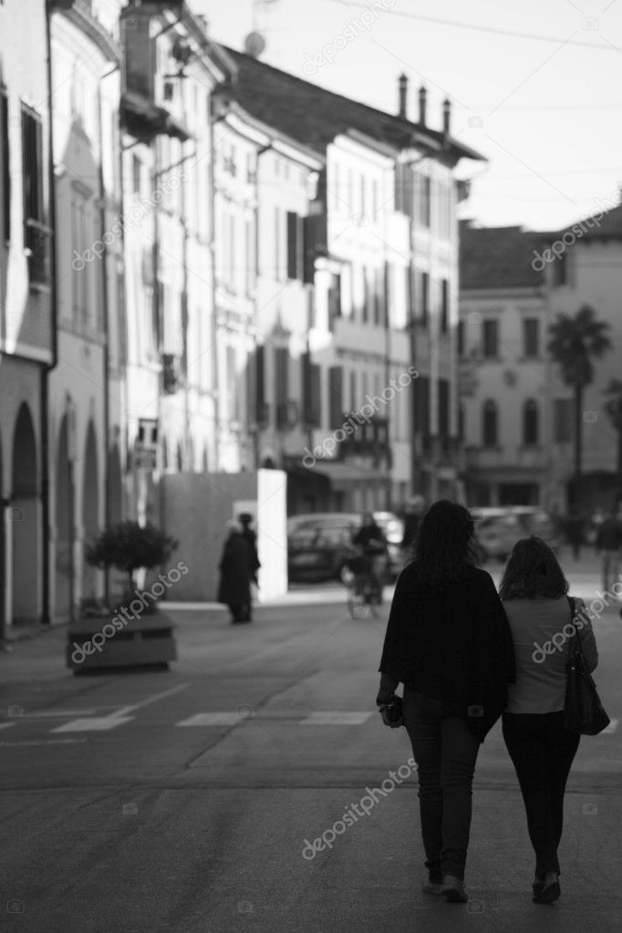 women stroll through typical Italian historic center, black and white