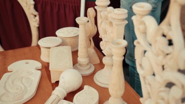 Wooden carved decorated objects are on table. — Stock Video