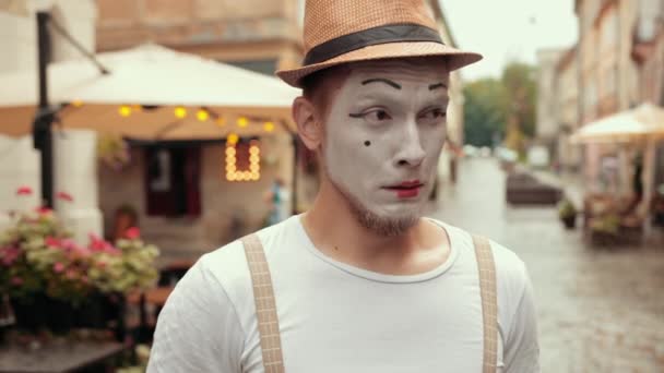 Mima i hatt, hängslen, vit makeup blir upprörd, ser upp med sorgligt ansikte. — Stockvideo