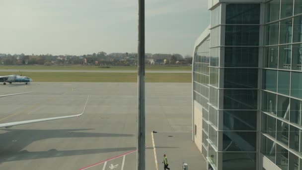 Samolot Motor Sich Airlines rusza za czarno-żółtym samochodem na pasie startowym. — Wideo stockowe