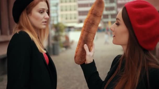 Zwei Französinnen in schwarzen Jacken und Baskenmützen messen sich bei der Bewertung — Stockvideo