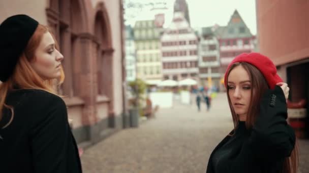 Zwei schöne Französinnen in schwarzen Jacken und roter Baskenmütze kämpfen mit Broten, — Stockvideo