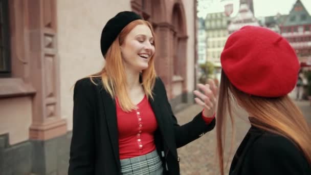 Two French women compete evaluating each other, but begin to smile at each other — 비디오