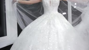 bride with crown on head posing in front of camera turns left to right.
