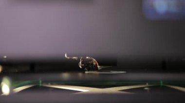3D technology close up of the printer head printing a plastic part product.