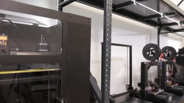 Impressoras de tiro largo de tecnologia 3D que imprimem peças plásticas na fábrica . — Vídeo de Stock