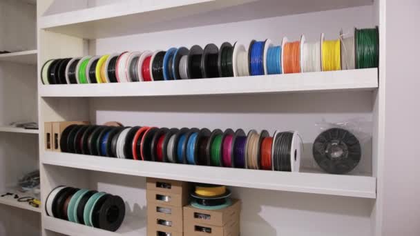 Man takes a spool with a plastic thread cable for color printing 3D printer — Stok video