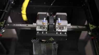 3D technology close up of the printer head printing a plastic part product.