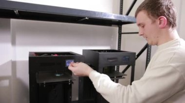 young man unwinds and extracts a red plastic thread cable from the coil.
