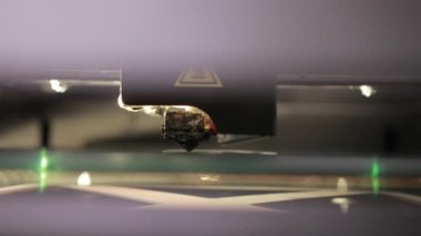 3D technology close up of the printer head printing a plastic part product.