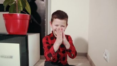cute guy shirt rubs his hands, shoves an electric plug into an outlet