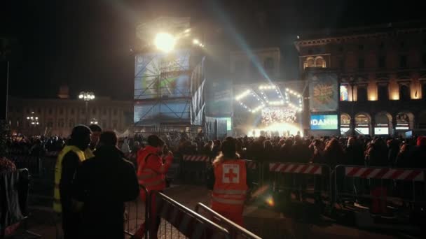 New years concert with a large crowd of people, in front the rescuers — Stock Video