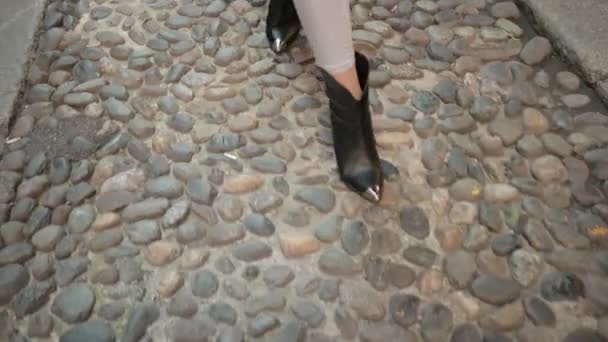 Womens Black Shoes Go On Pavement, Not Equal To Stones That Make Up The Road . — Stock Footage Womens Black Shoes Go On Pavement, Not Equal To Stones That Make Up The Road . Royalty Free Stock Footage