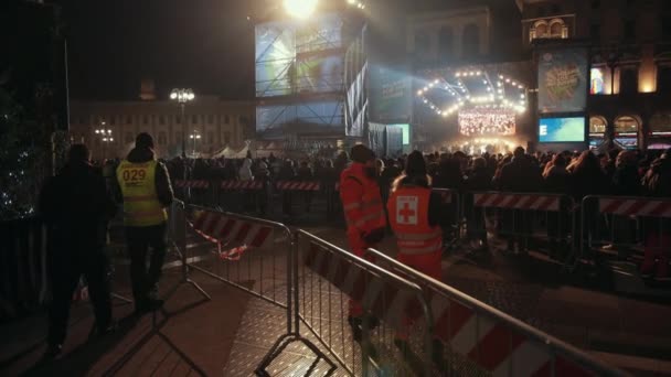 New years concert with a large crowd of people, in front the rescuers — Stock Video