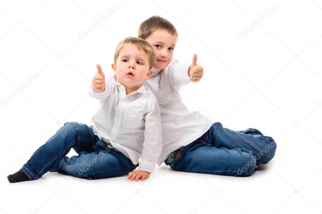 2 boys sitting thumbs up