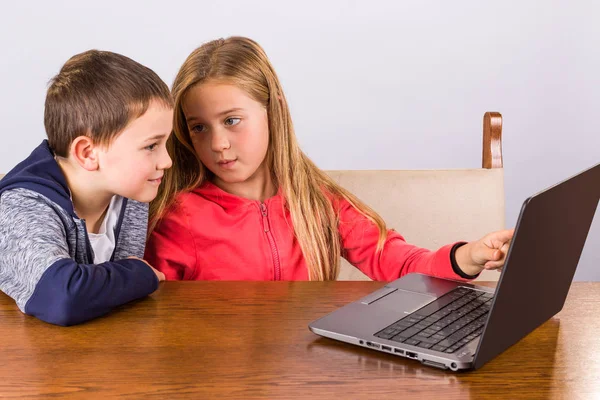 Menino e menina com laptop — Fotografia de Stock