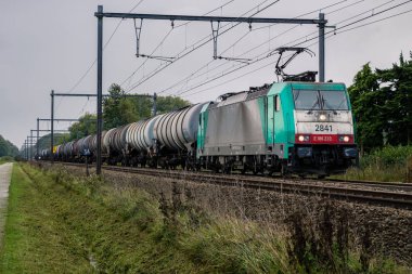 Begijnendijk, Flanders, Belgium - October 17 2013 : Electrical train type Bombardier TRAXX in front of freight train with tank cars